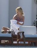 Jessica Simpson shows her boobs (downblouse, rubbing) in small bikini as she sunbathe at Cabo San Lucas